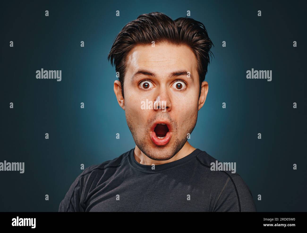 Young man with funny big head emotional wow portrait Stock Photo