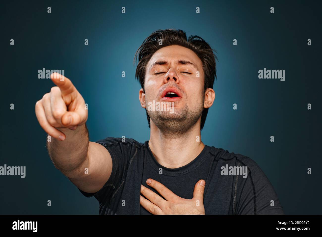 Young man pointing with finger and laughing Stock Photo