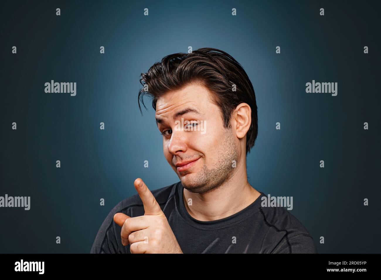 Young brunette man pointing with finger portrait Stock Photo