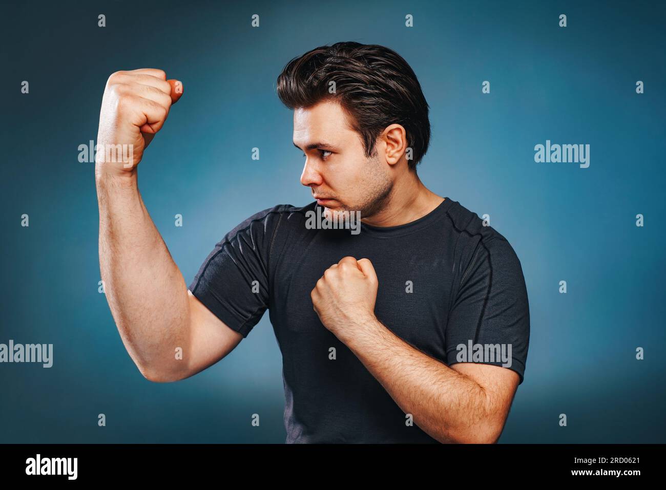 Young brunette man fighter with cartoon big hand Stock Photo