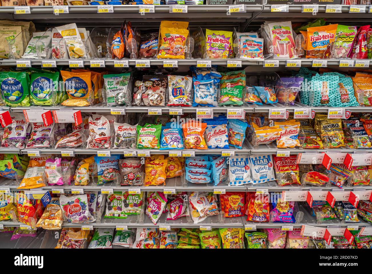 Italy - July 17, 2023: Candies of various types and brands in packets for sale on Italian supermarket shelves Stock Photo