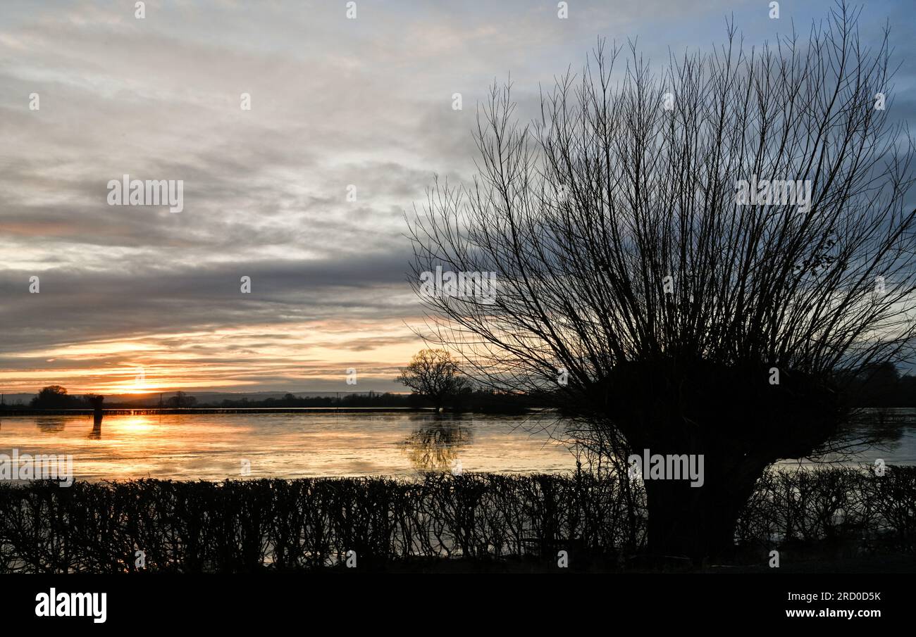 Flooded and Frozen Somerset Levels near Highbridge and Burrow Hill Sunrset winter Stock Photo