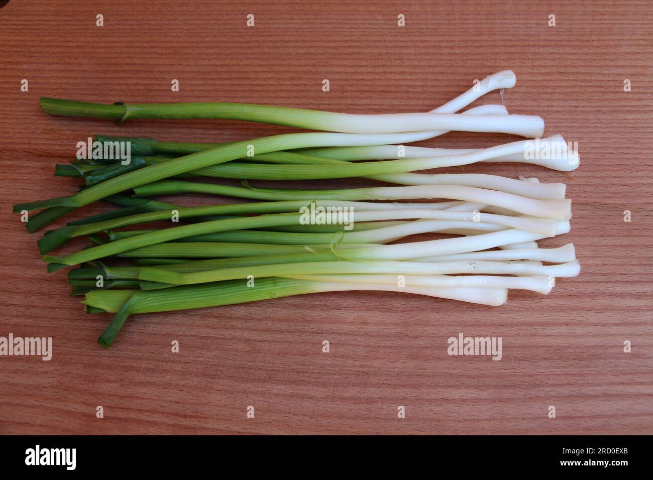 A bunch of peeled young garlic is on the kitchen board Stock Photo - Alamy