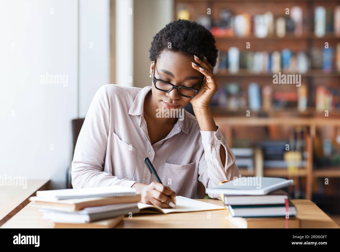 Being Rushed Taking Notes Concentrated woman student taking notes at table in coffee shop Stock ...