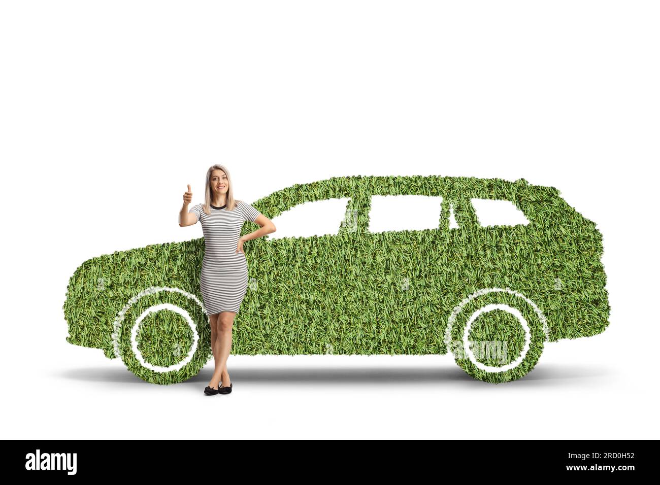 Full length portrait of a woman leaning on a green car made of grass and gesturing thumbs up isolated on white background Stock Photo