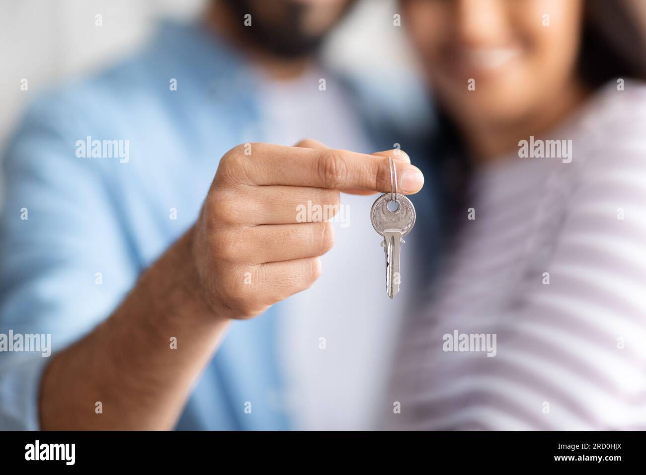 Unrecognizable couple at new home, holding house keys Stock Photo - Alamy