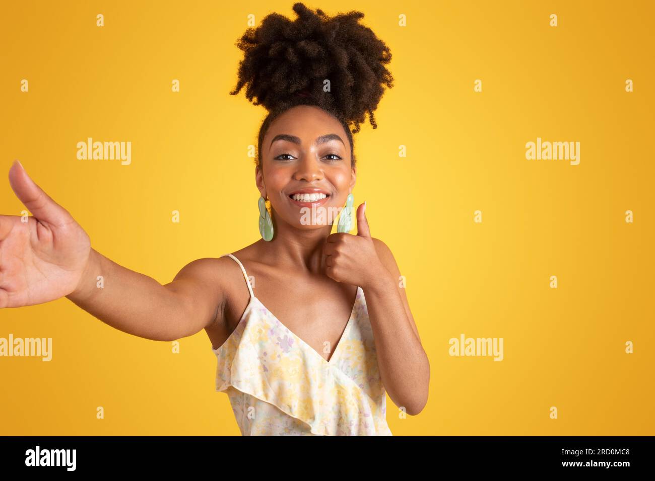 Cheerful young black woman in dress taking selfie, show thumb up Stock  Photo - Alamy, image size:1300x956