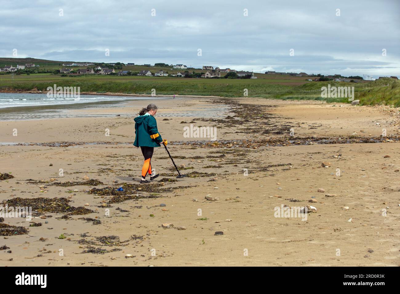 Dunnet Bay, Caithness, Scotland, July 4th 2023, a metal detectors combs the sands on the beach, searching for lost metal items. Stock Photo