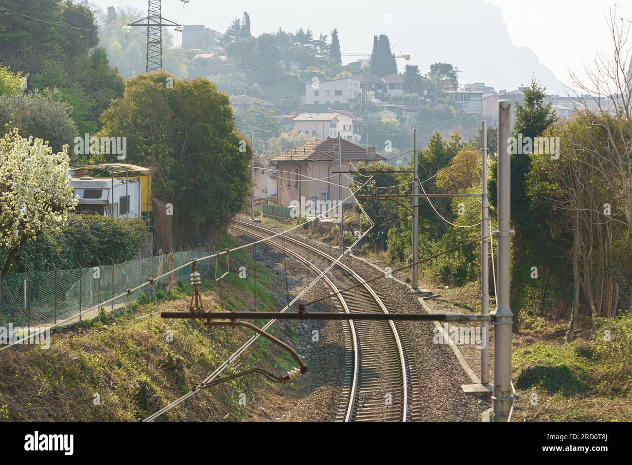 Railroad tracks with mountains on background. Rural industrial landscape. Transportation, railroad travel Stock Photo