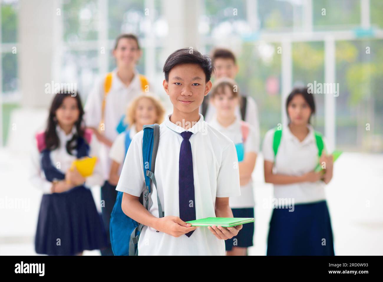Kids go back to school. Interracial group of children of mixed age on the first day of new academic year. Teenager in classroom. Stock Photo