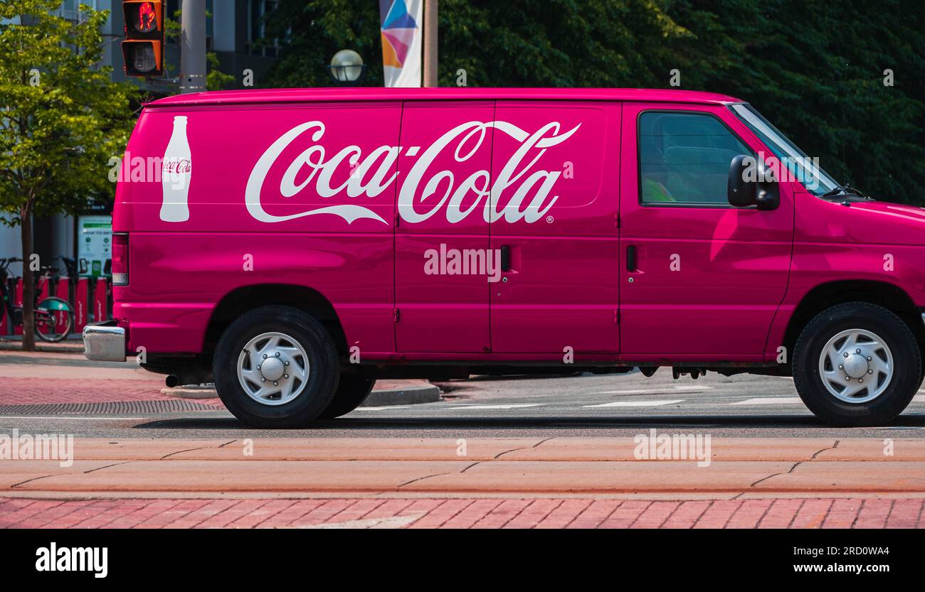Coca Cola van on the road, delivering coke beverages to stores and restaurants. Food and drink delivery. Coca Cola company van.Coca Cola truck driving Stock Photo