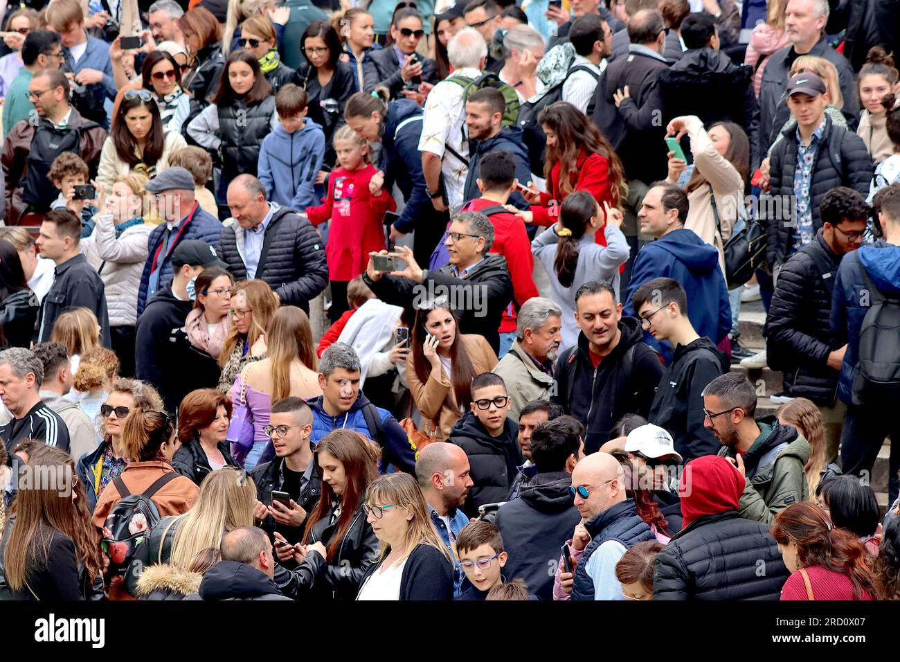 Large crowds of tourists and Italians gather to view the Trevi fountain despite overcast weather combined with a four day Italian Bank Holiday. Stock Photo