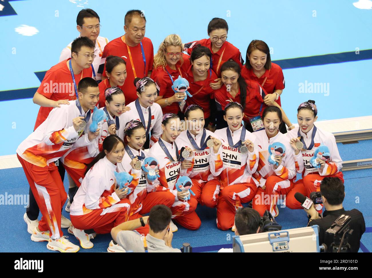 The China team poses with their gold medals after competing in the team acrobatic routine final