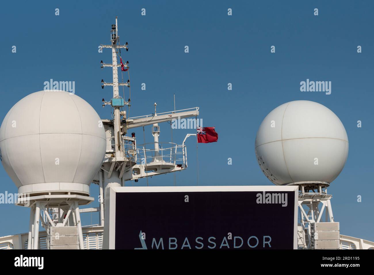 North Sea off UK coast. 2nd June 2023.  Radomes above deck on a cruise ship flying red ensign flag. Stock Photo