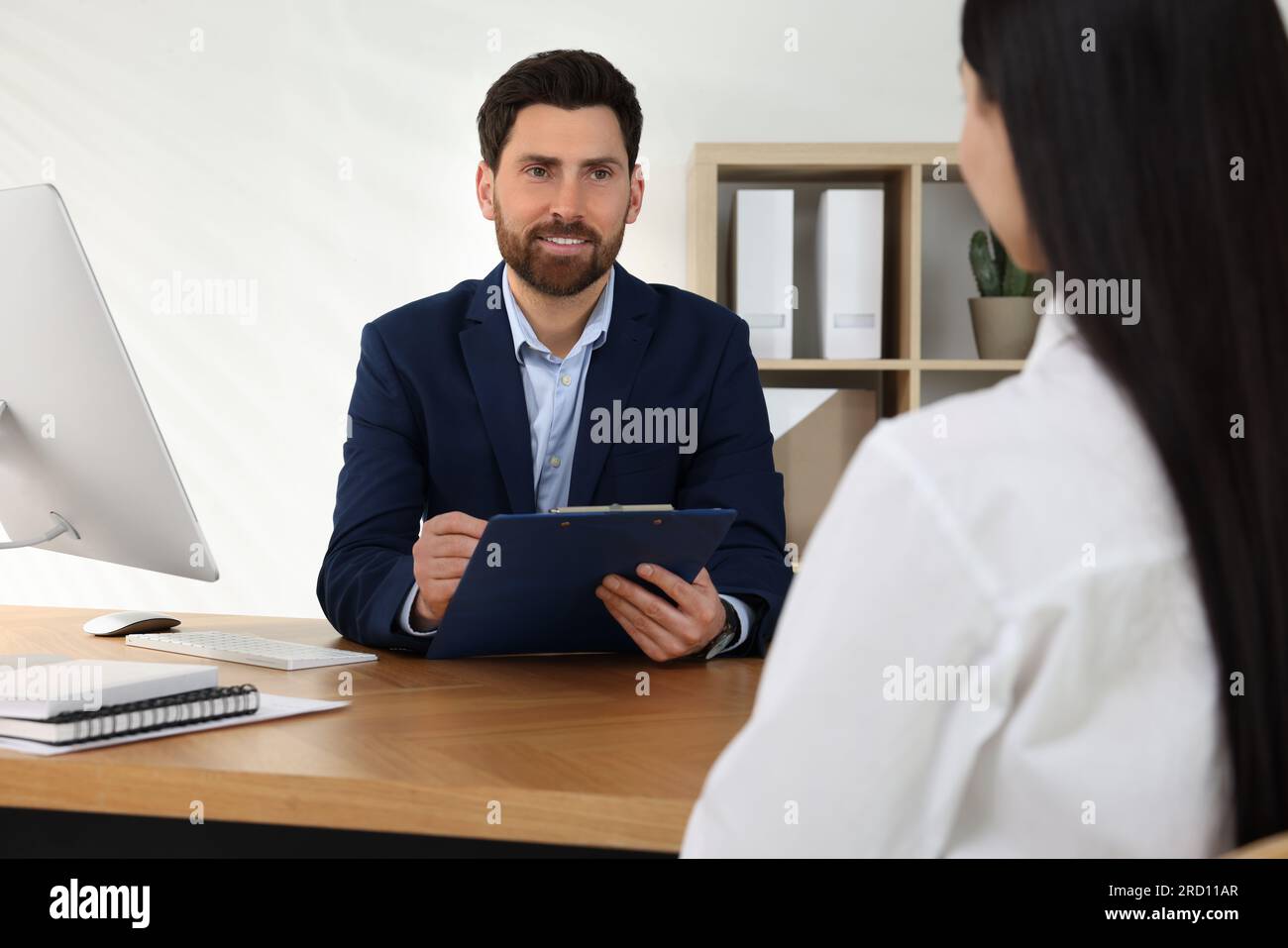 Human resources manager conducting job interview with applicant in ...