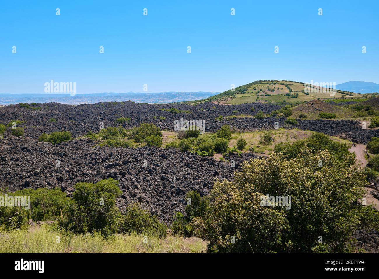 Manisa, Turkey - July 12, 2023: Volcanic tuff deposit and local vegetation in Kula National Geopark Stock Photo