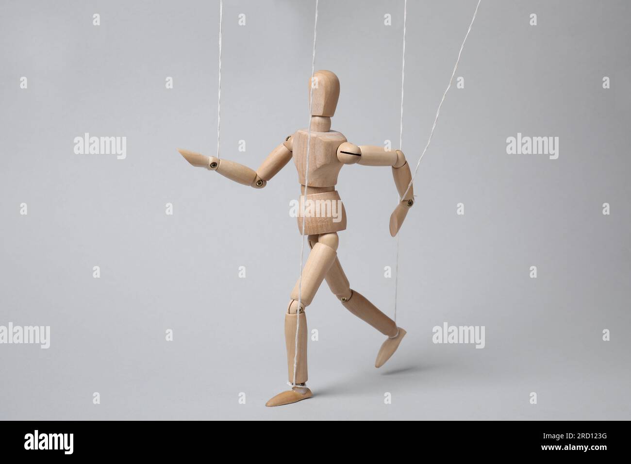 Staight Puppet One wooden puppet with strings on light grey background Stock Photo - Alamy