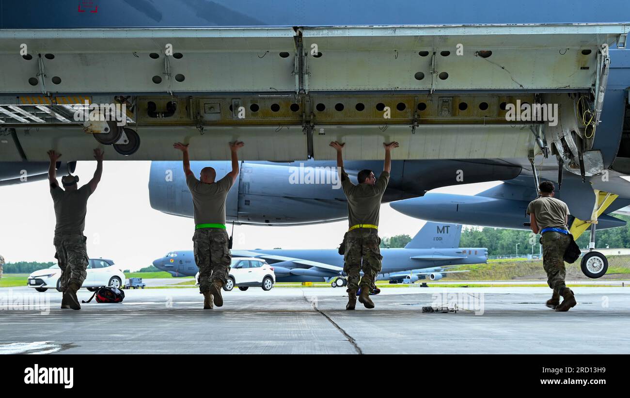 (From left to right) Staff Sgt. Julian Montanez, Tech. Sgt. Michael Piland, Senior Airman Matthew McMahon and Airman 1st Class Timothy McDonald prepare the bomb bay of a B-52H Stratofortress for unloading at Joint Base Elmendorf-Richardson, Alaska, July 11, 2023. The maintenance Airmen were sent to JBER in support of a bomber Agile Combat Employment exercise. (U.S. Air Force photo by Senior Airman Zachary Wright) Stock Photo