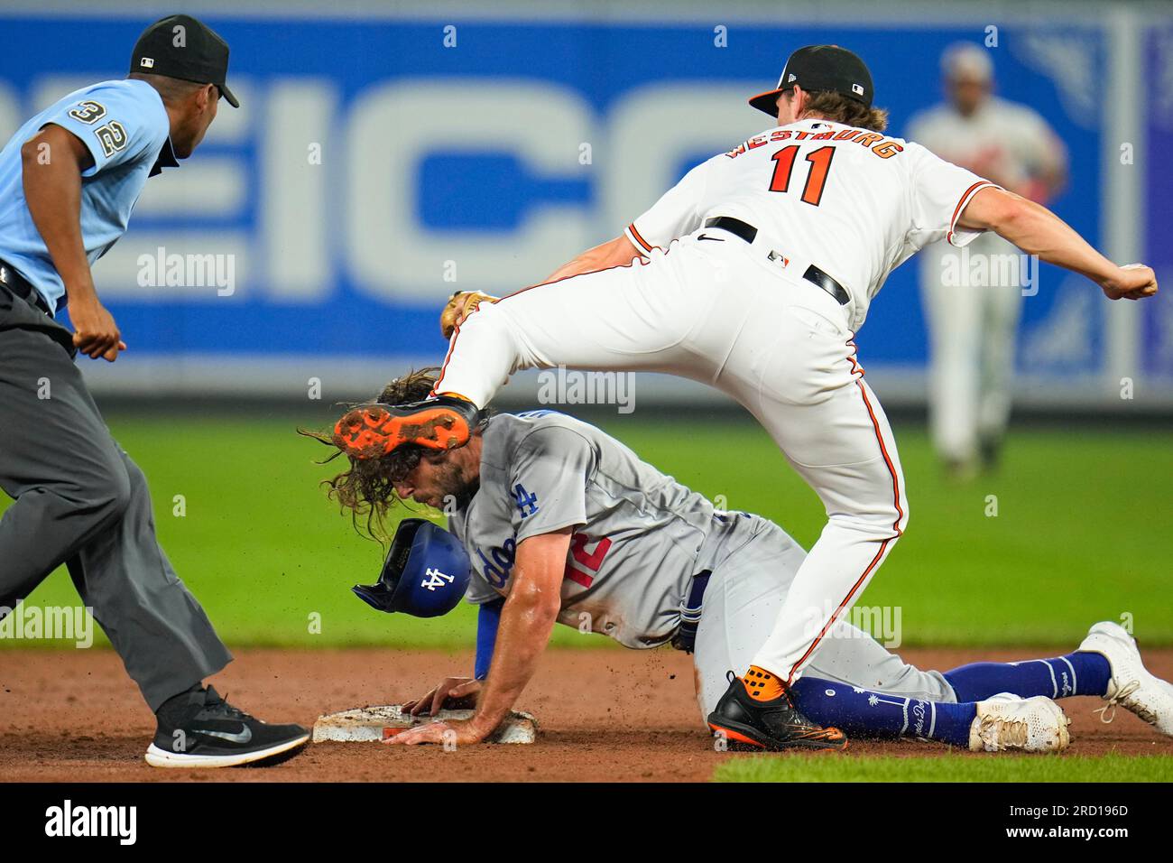 Los Angeles Dodgers' Jake Marisnick, bottom, is tagged out by Baltimore  Orioles third baseman Jordan Westburg (11) while trying to steal second as  umpire Edwin Moscoso during the eighth inning of a
