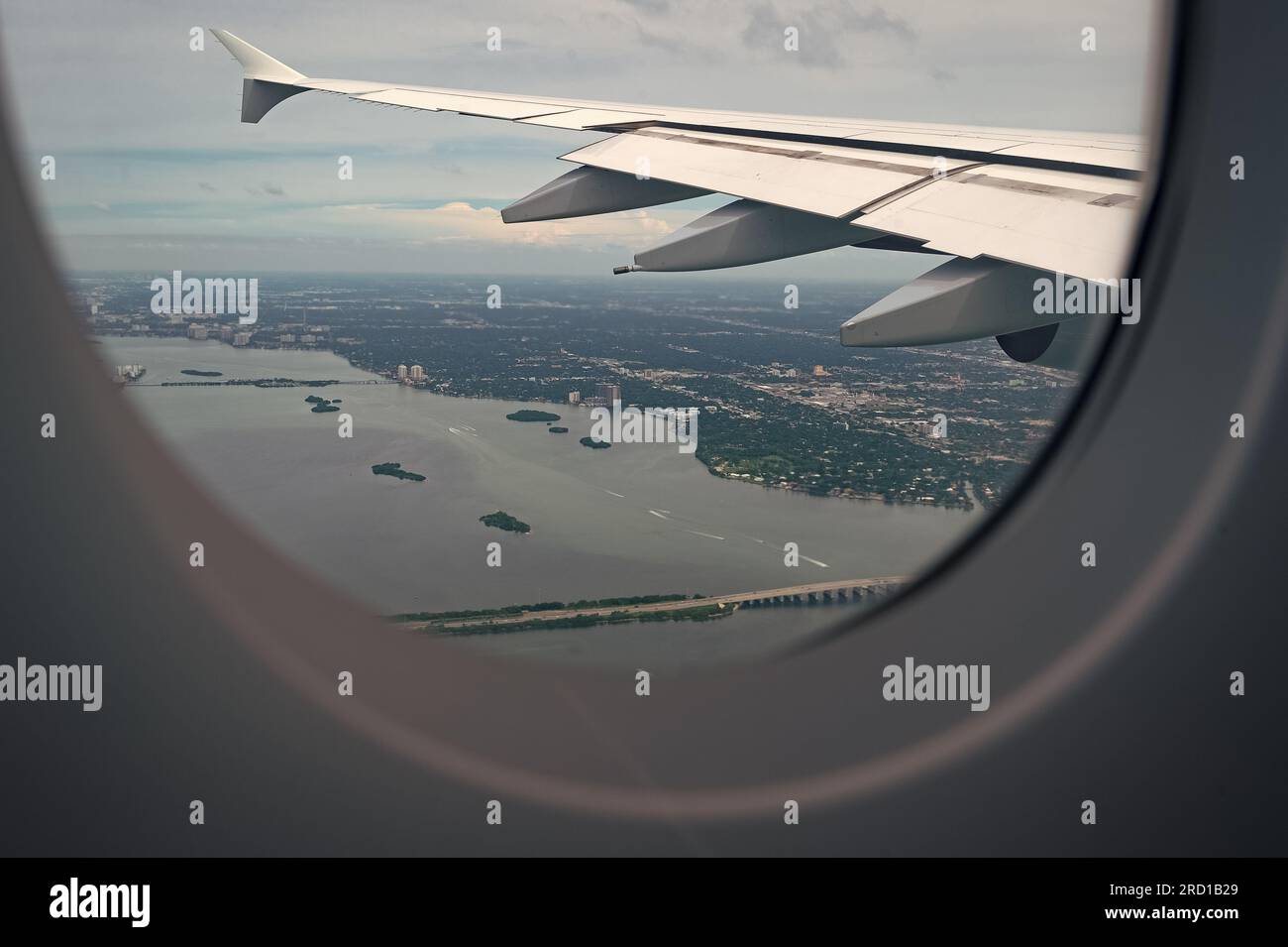 View from porthole. Aircraft window or porthole. Aircraft wing seen