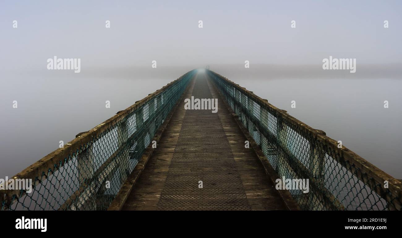 A diminishing perspective of a bridge on a misty day in Tasmania, Australia Stock Photo
