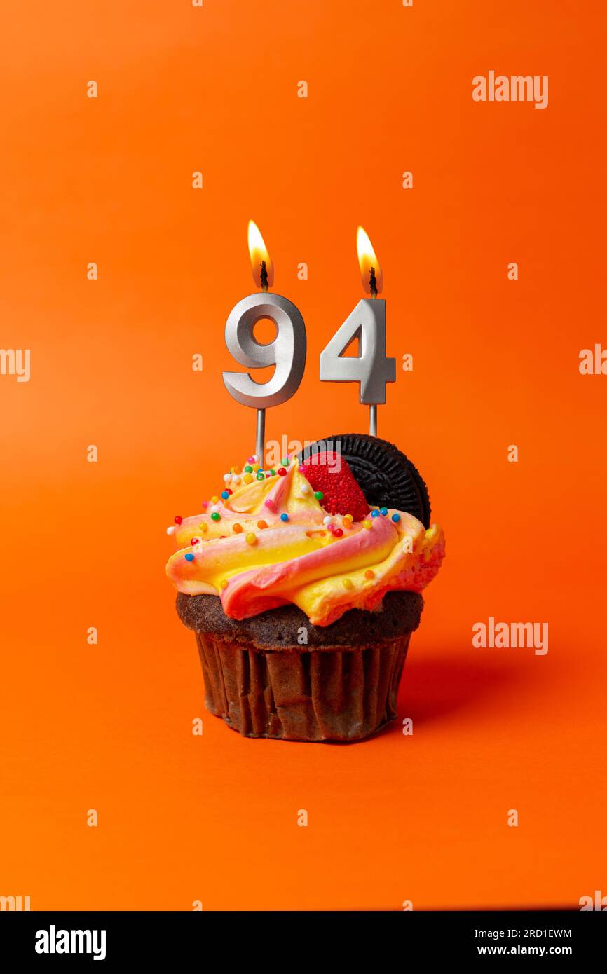 birthday cake with number 94 - cupcake on orange background with ...