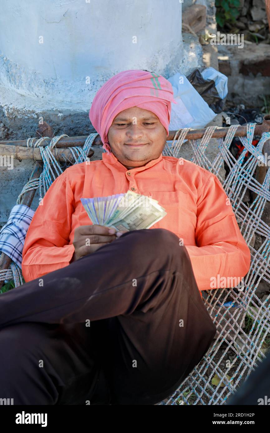 Happy Indian farmer, farmer holding indian rupees in hands, smart ...