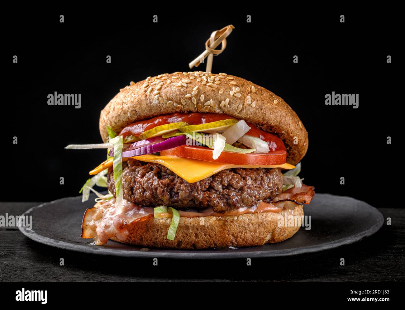 fresh tasty burger on black plate Stock Photo