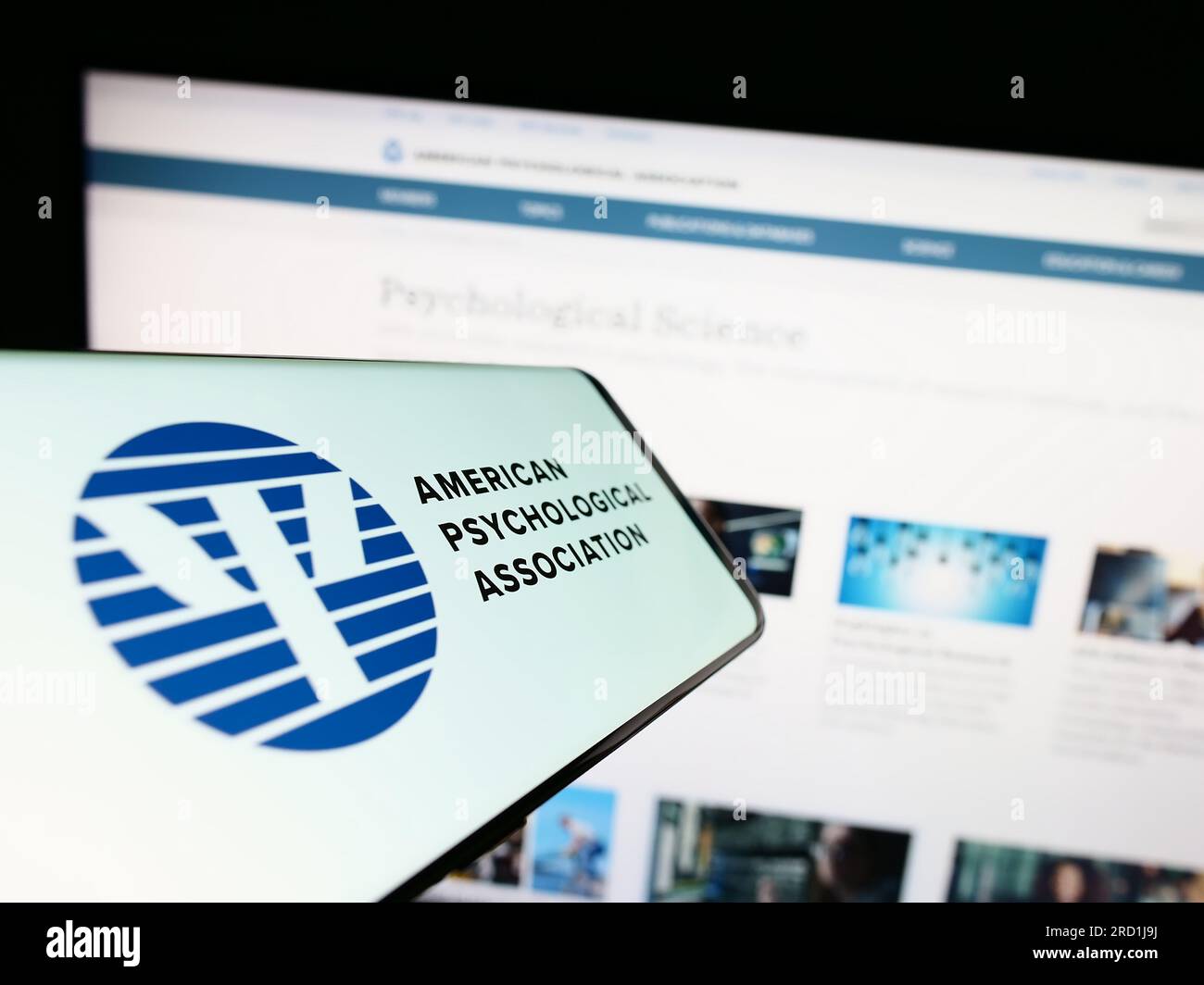 Smartphone with logo of American Psychological Association (APA) on screen in front of website. Focus on center of phone display. Stock Photo