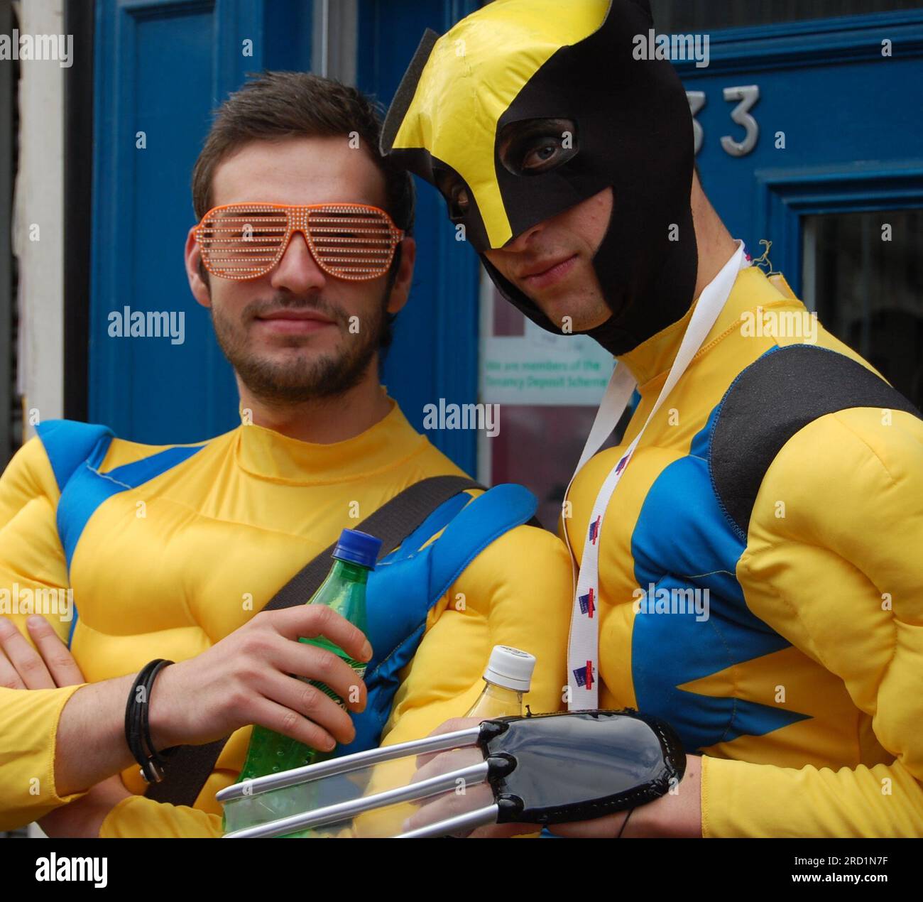 Two men wear matching, striking, vibrant, colourful yellow and blue