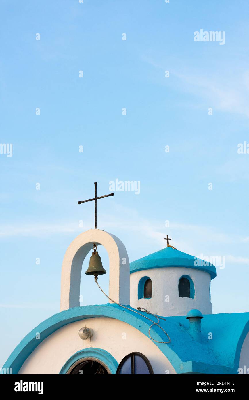 Top of Agios Dionysios church against a blue evening sky - Crete, Greece Stock Photo