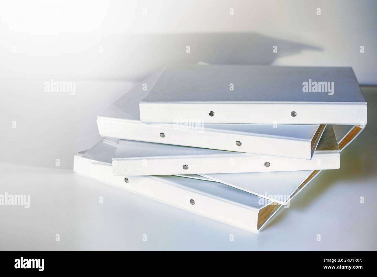 Stack of white file folder or ring binder waiting to be processed in an office, administration and business work concept, copy space, selected focus, Stock Photo