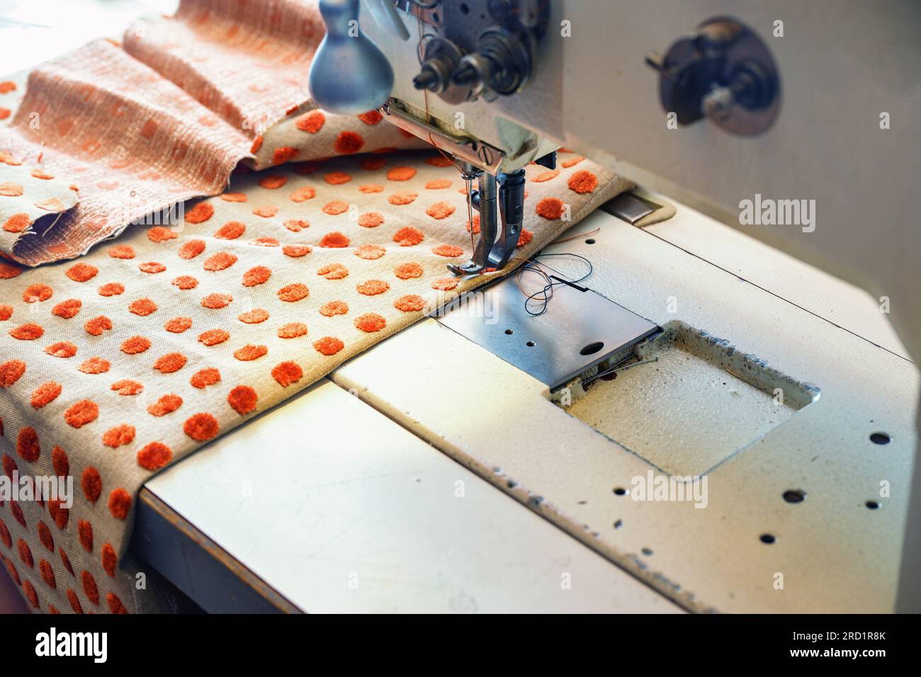 Industrial sewing machine processing an upholstery fabric for home