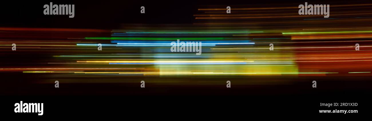 Abstract Rainbow light trails on the dark background Stock Photo - Alamy
