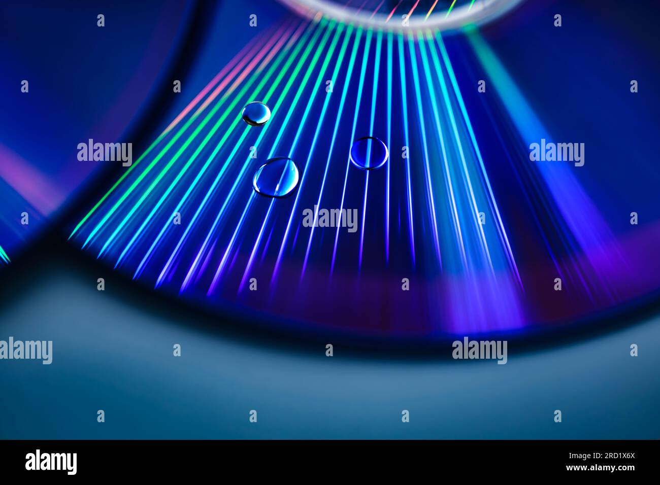 abstract rainbow light rays reflection on cd surface with water drops ...