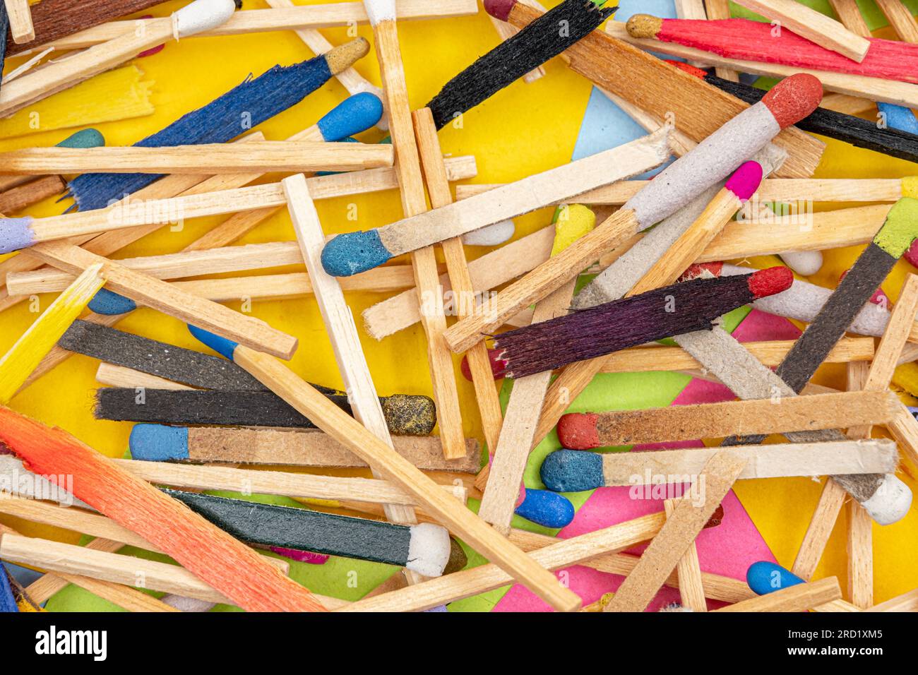 matchsticks of various shapes and colors with multicolored paper sticky notes on background Stock Photo