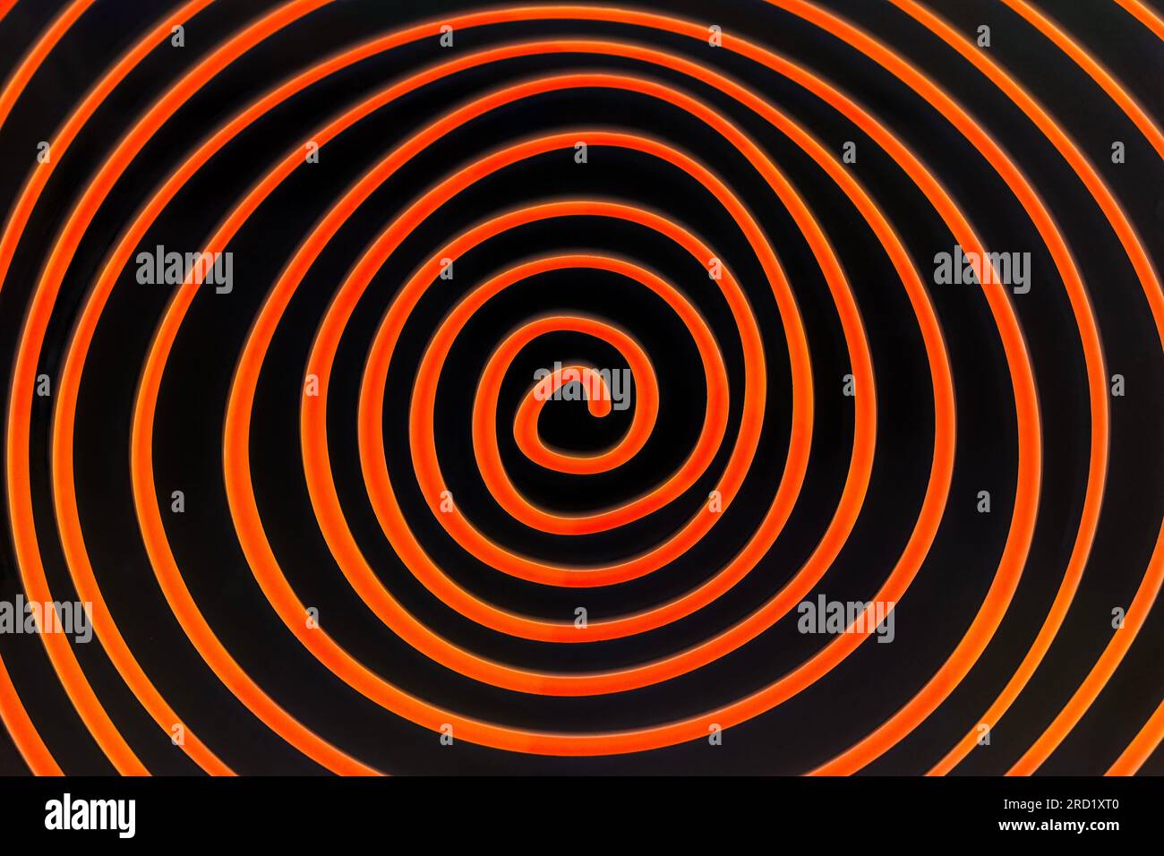 Simple orange spiral on dark background Stock Photo