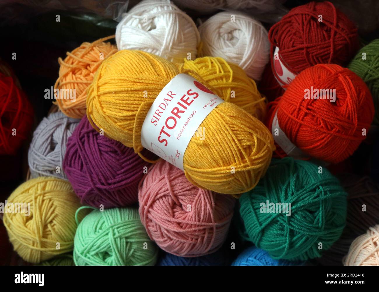 Balls of knitting wool, in a shop in Filey, North Yorkshire, England, UK, Stock Photo