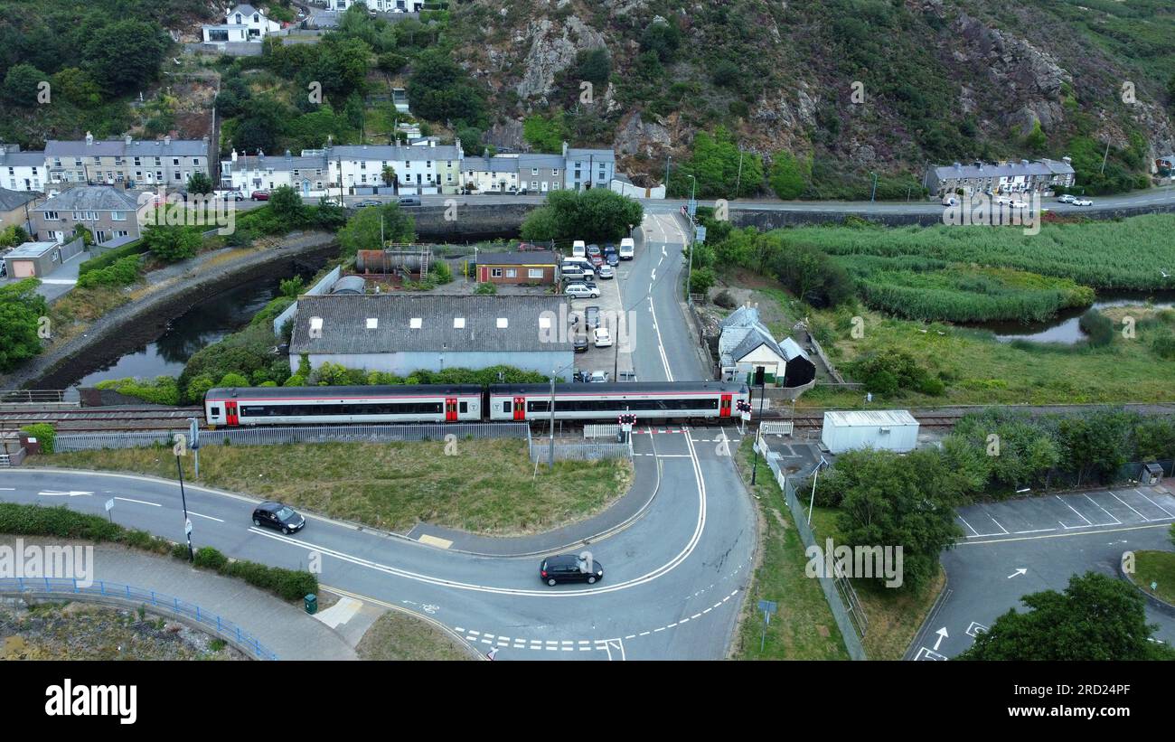 Drone view of  A Transport for Wales train at Afon Erch crossing, Pwllheli, Gwynedd, Wales, July 2023 Stock Photo