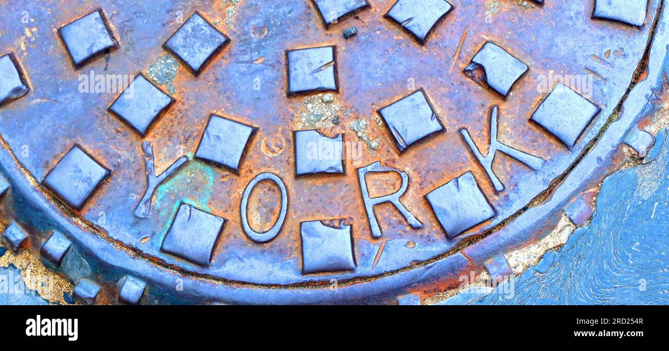 York embossed rusty cast iron sewer grid, York , Yorkshire, England, UK, YO1 Stock Photo