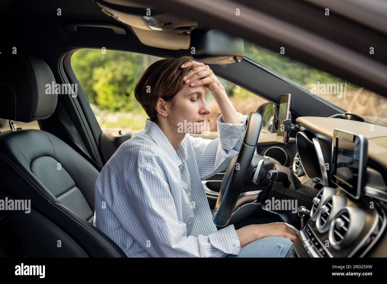 Tired woman stopped after driving car, thinking about life troubles, has panic attack. Burnout