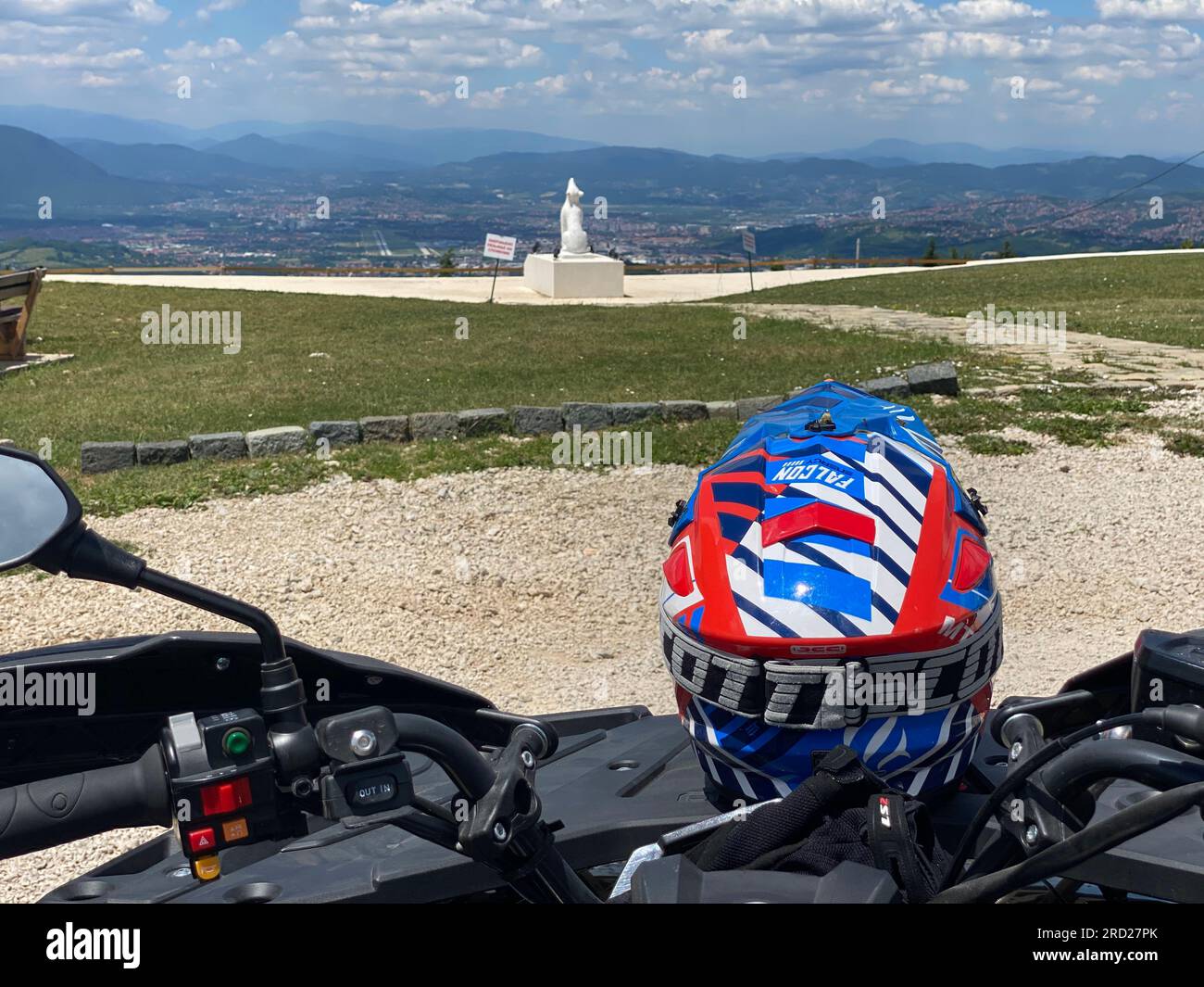 Ready for Action Blue and Red Helmet on ATV Quad backside view Stock