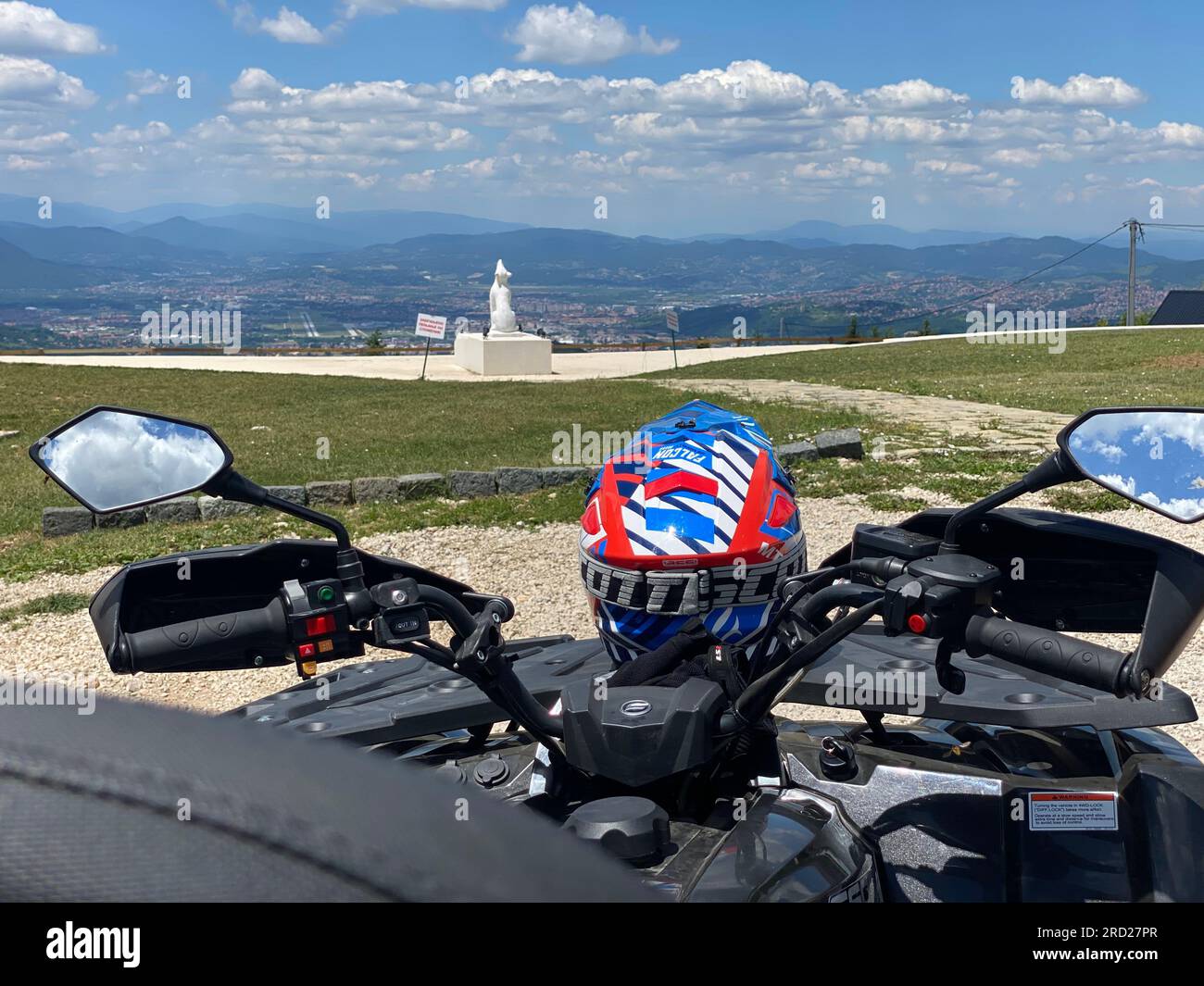 Ready for Action: Blue and Red Helmet on ATV Quad backside view Stock Photo