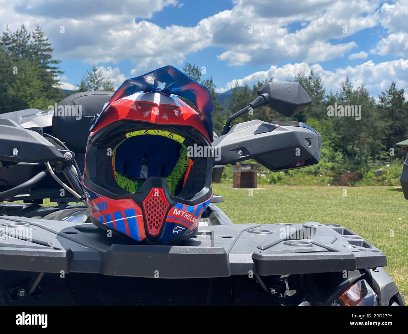 Protective Gear Blue and Red Helmet on ATV Quad front view Stock Photo