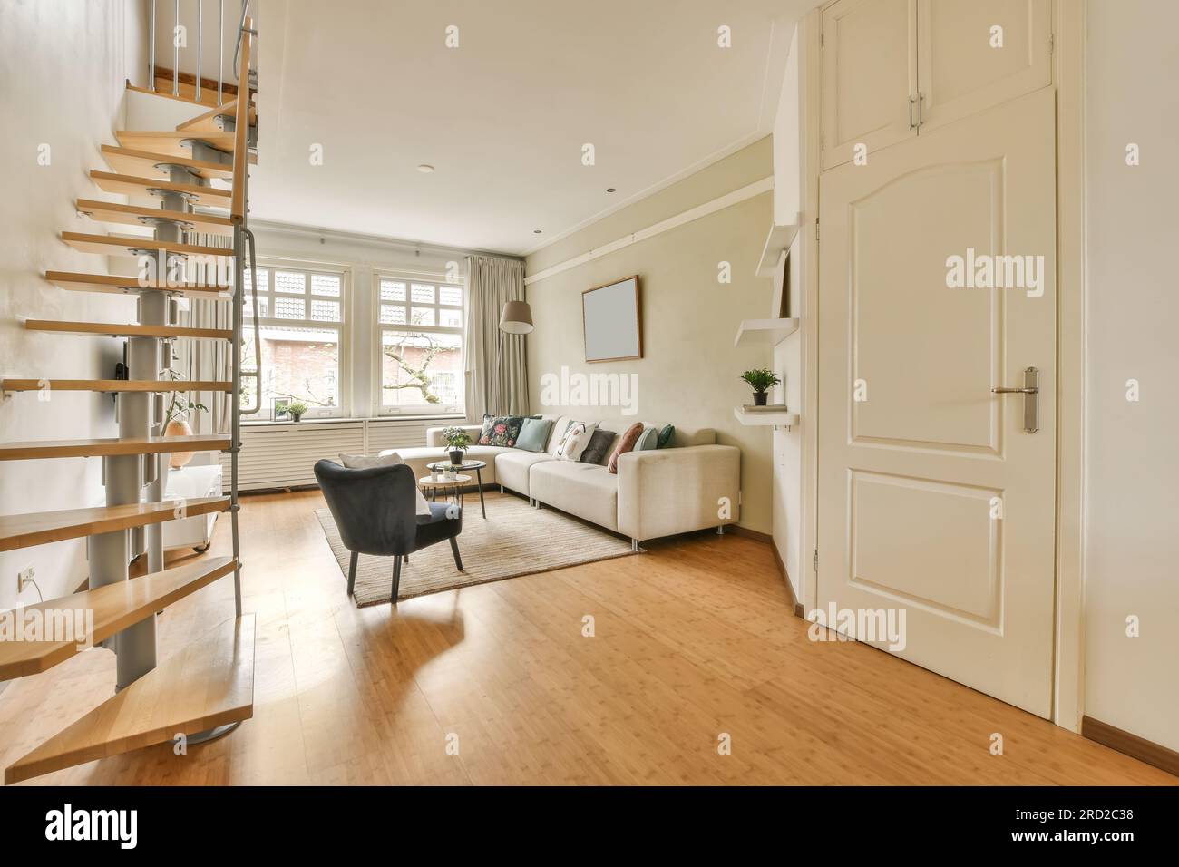 a living room with wood flooring and stairs leading up to the second