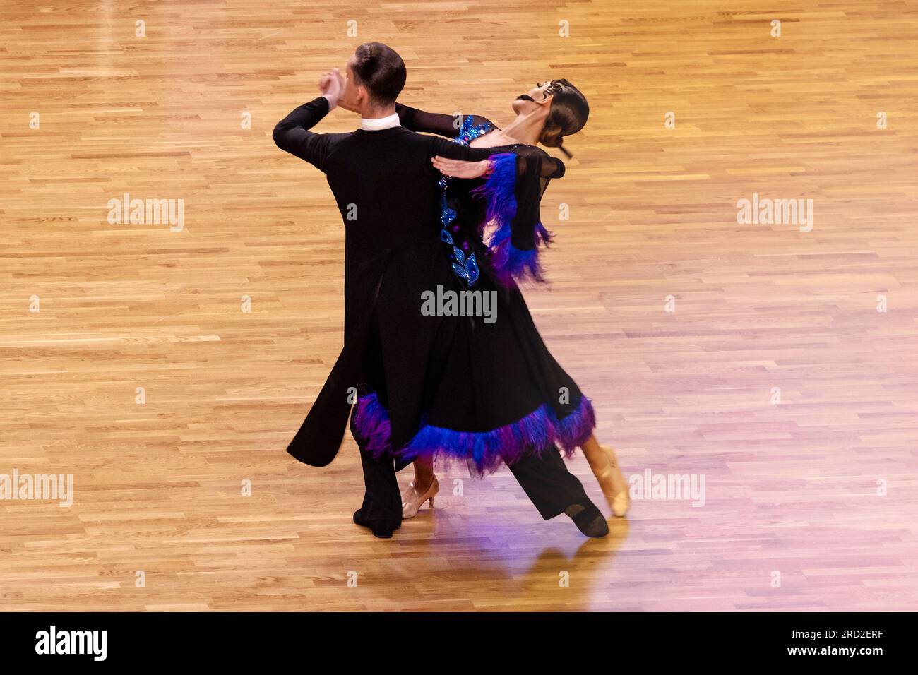 partner dancers in black dress at dance sport competition, slow waltz dance Stock Photo