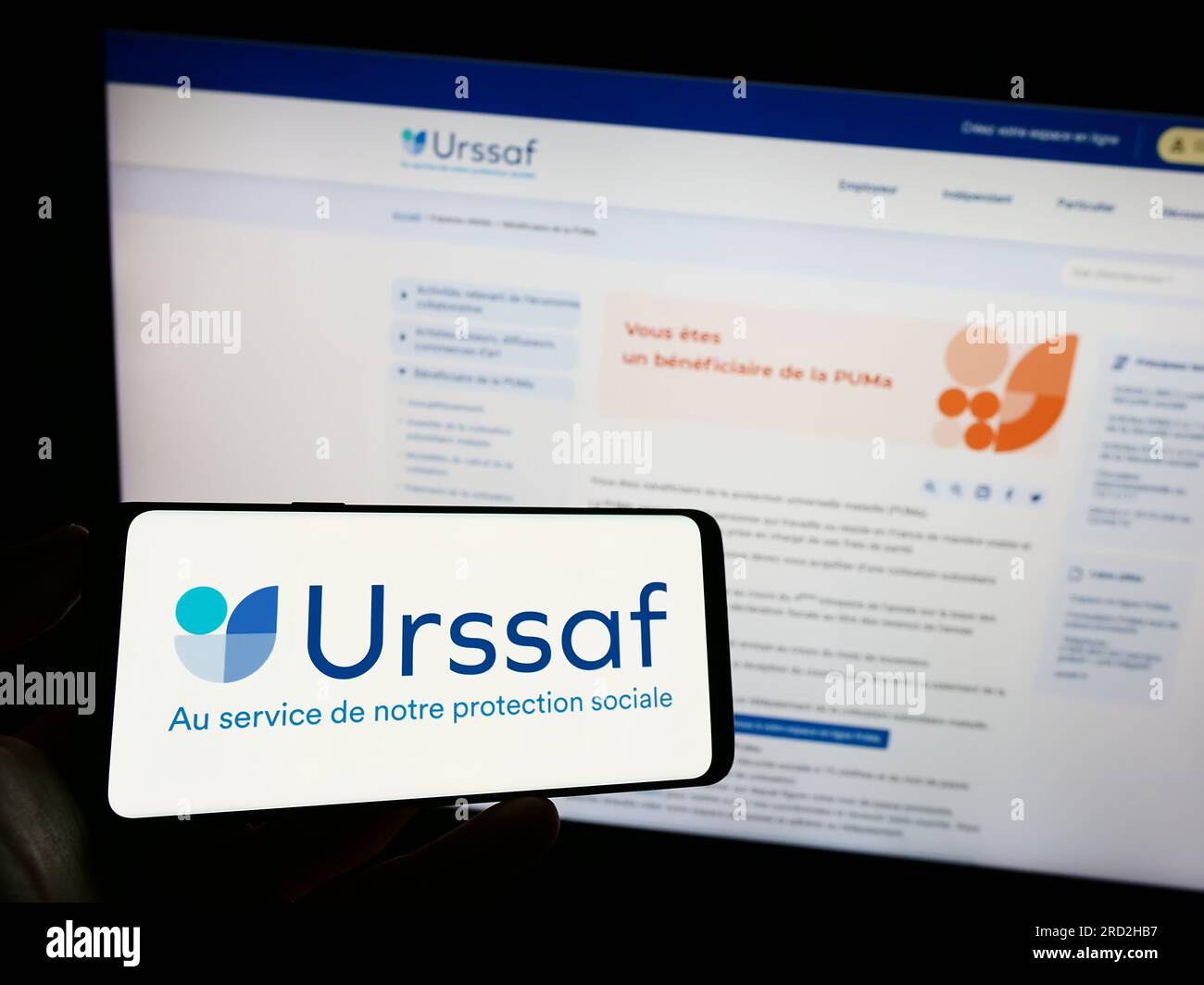 Person holding mobile phone with logo of French social security  organization URSSAF on screen in front of web page. Focus on phone display  Stock Photo - Alamy