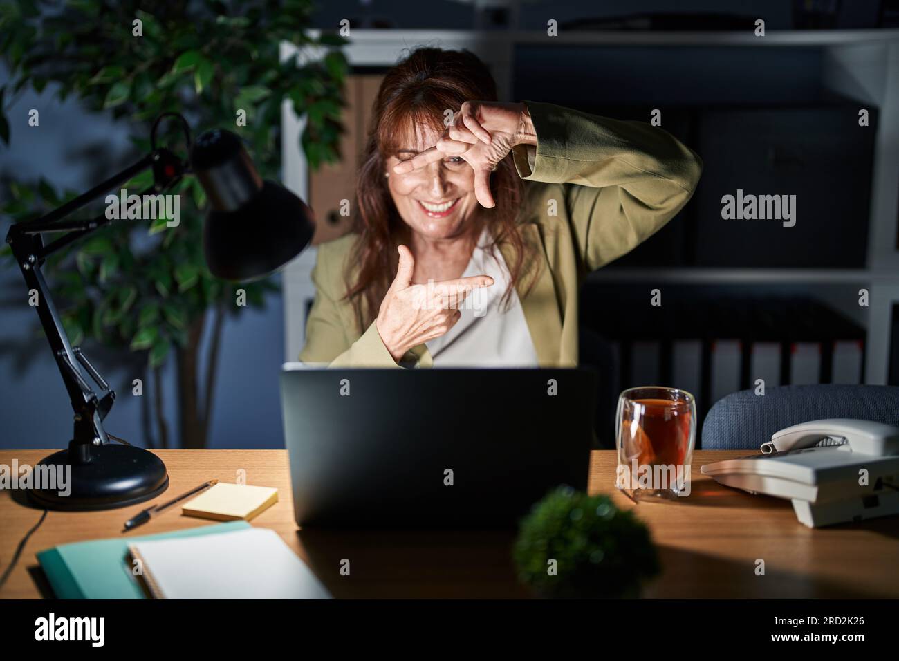 Middle age hispanic woman working using computer laptop at night ...