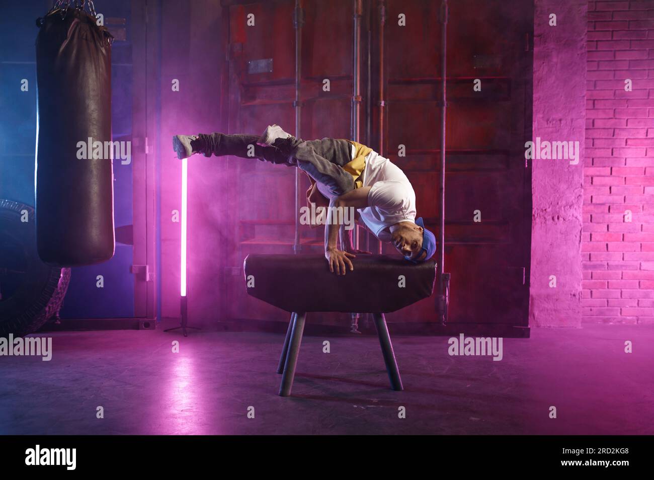 Male hip hop dancer on head stand doing acrobatic stunt Stock Photo