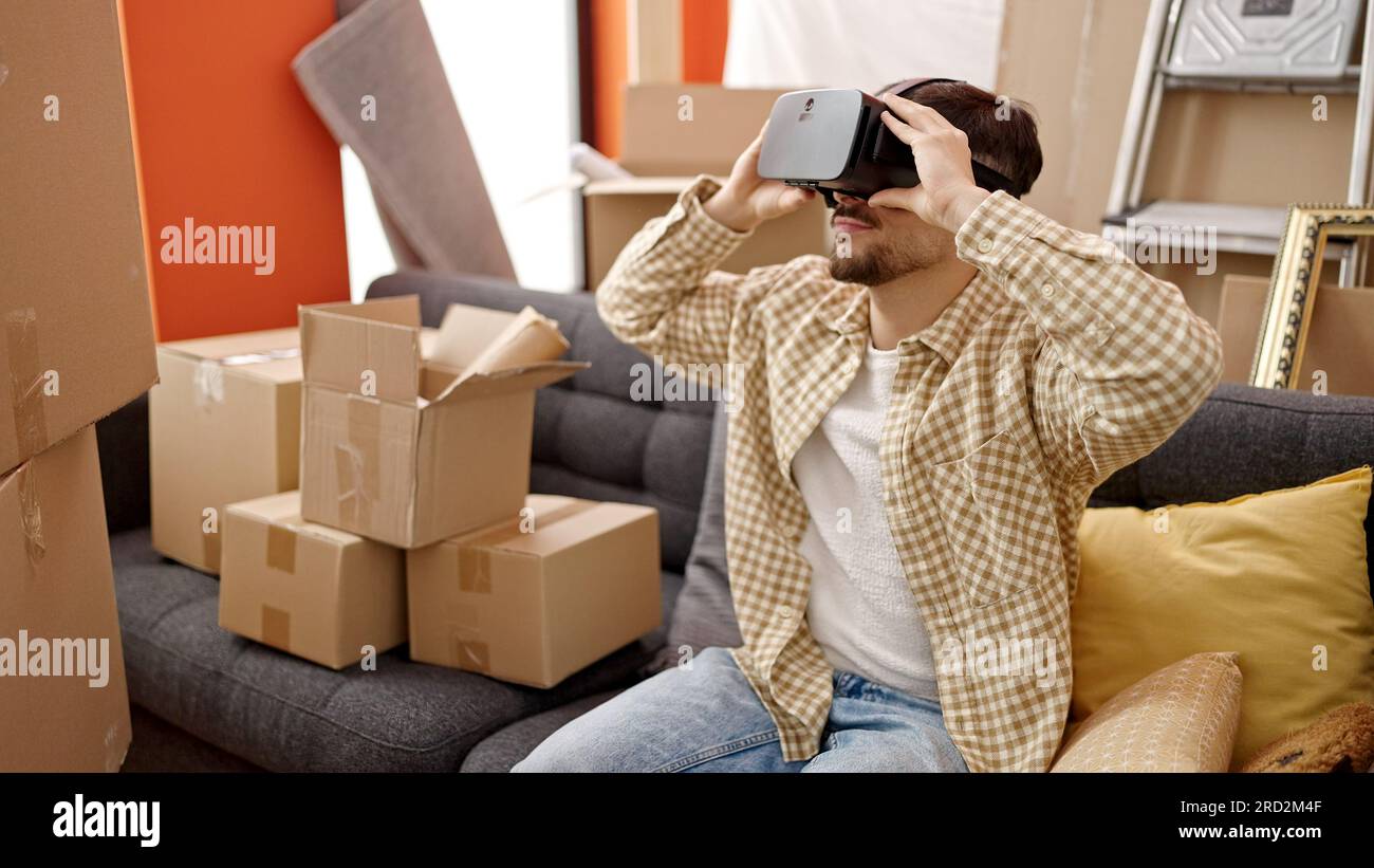 Young arab man using virtual reality glasses at new home Stock Photo